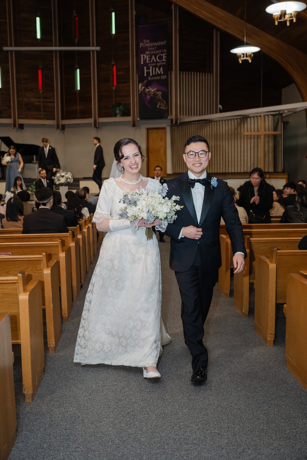 couple walk up aisle after vows in seattle church