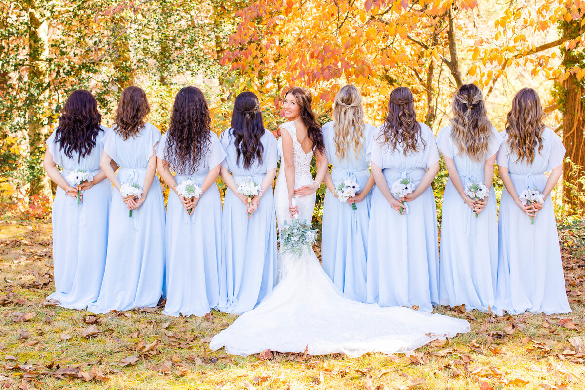 bridesmaids turned around posing with their bouquets