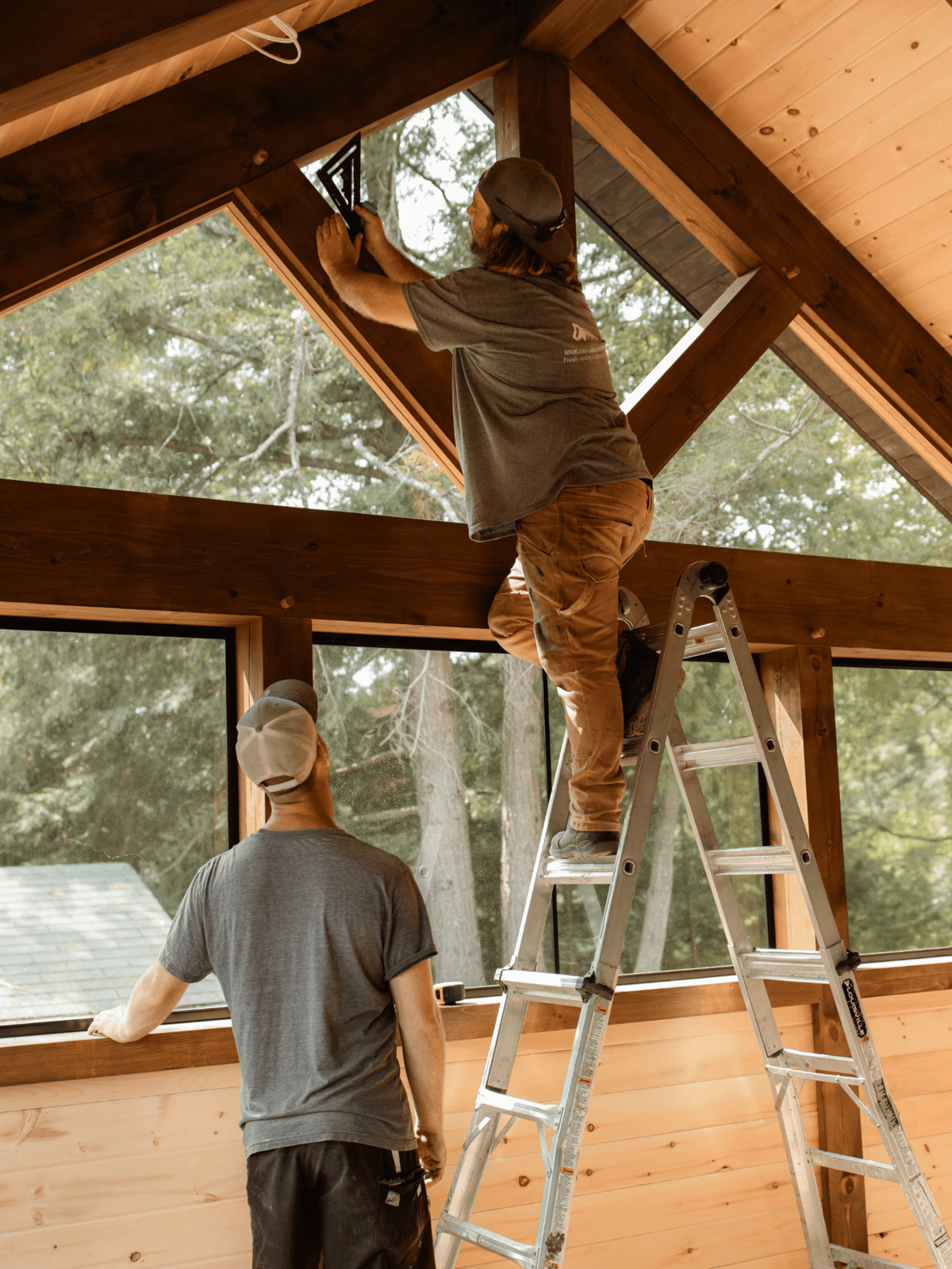 Luxury timber frame home project in Haliburton Highlands with exposed beams, vaulted ceilings, and custom woodwork.