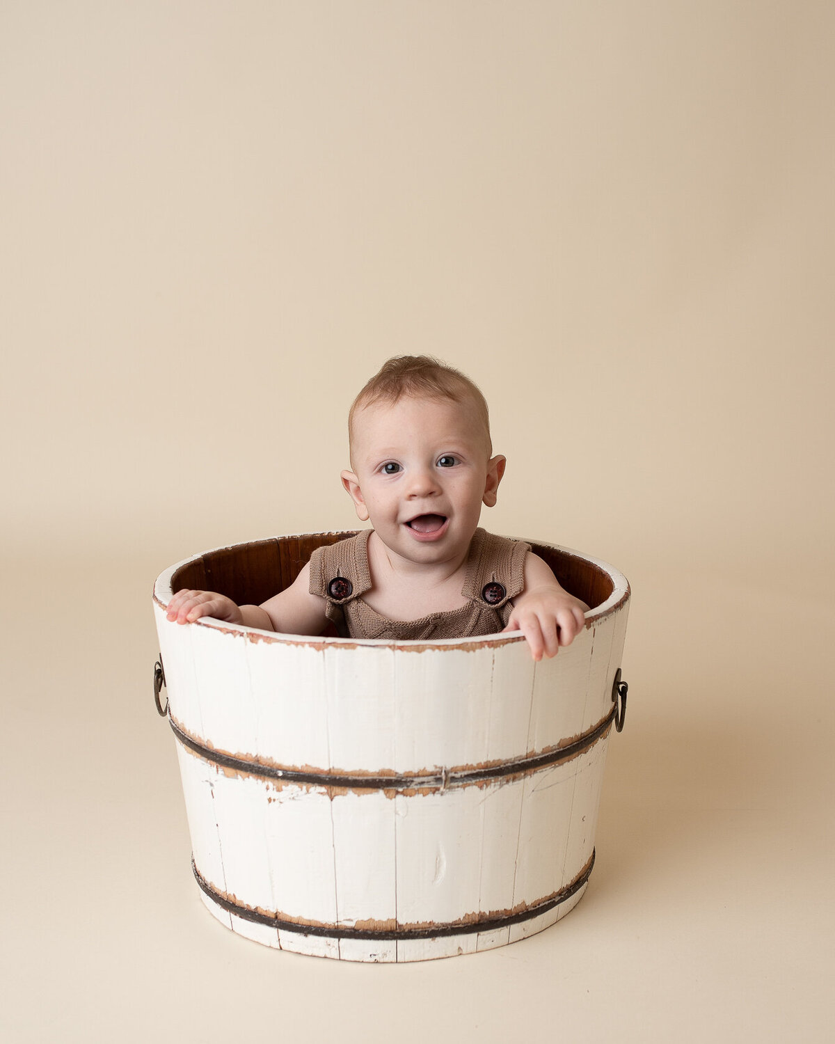 Baby in a bucket photography by Laura King