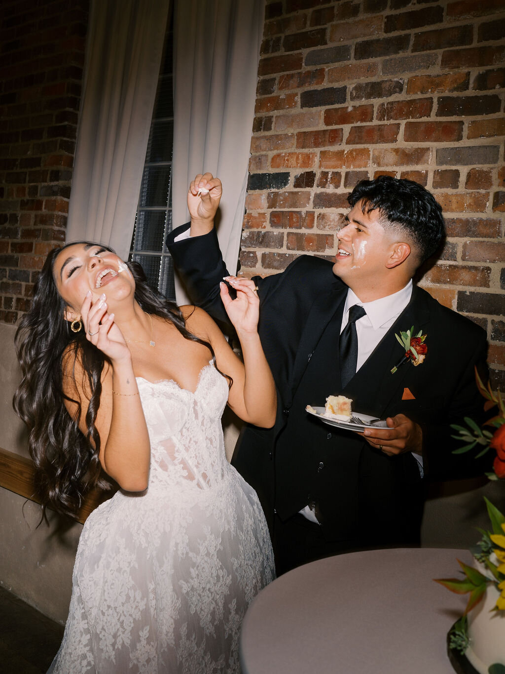 A bride and groom cut their cake in a documentary wedding photo at Upper Larimer in Denver, Colorado.