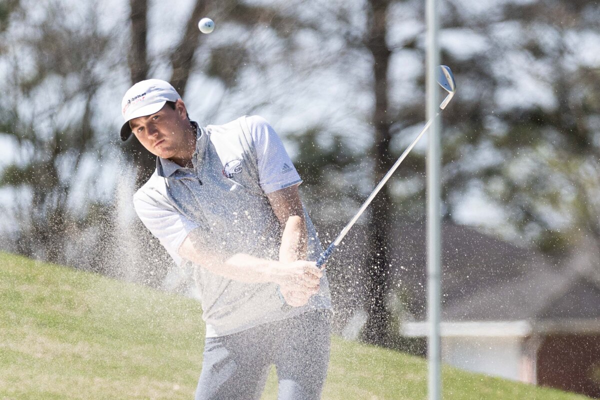 Dawson Atkinson of Trussville, Alabama hits out of the sand during a tournament at Robert Trent Jones golf course in Mobile, Alabama.