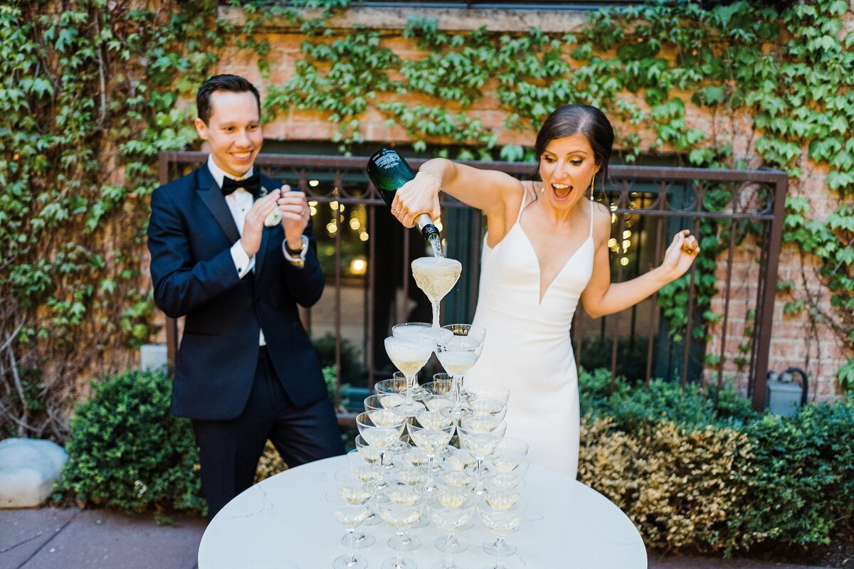 bride and groom pouring champagne tower