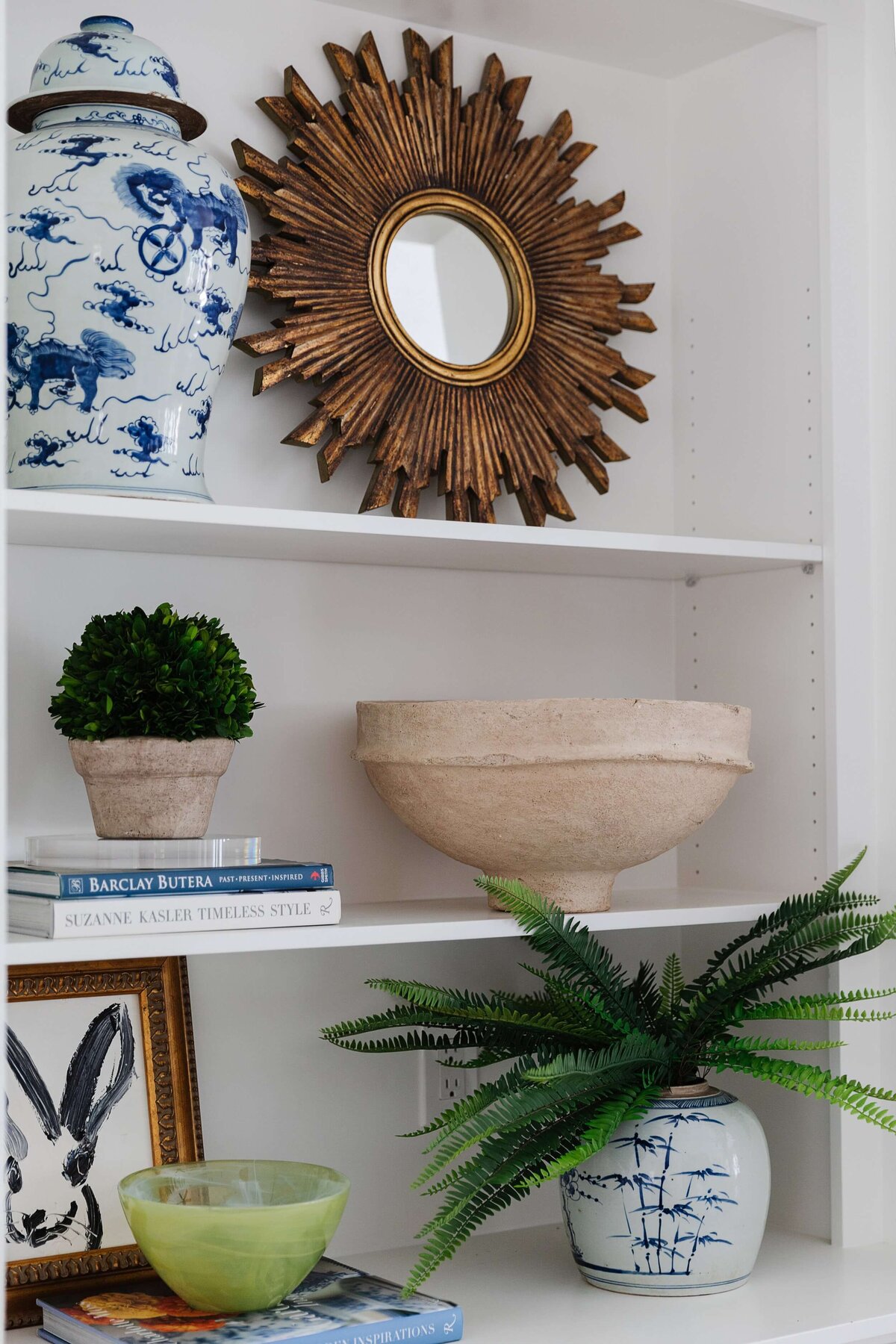oyster creek studios home on the range decorative mirror vase plants and artwork on white shelves