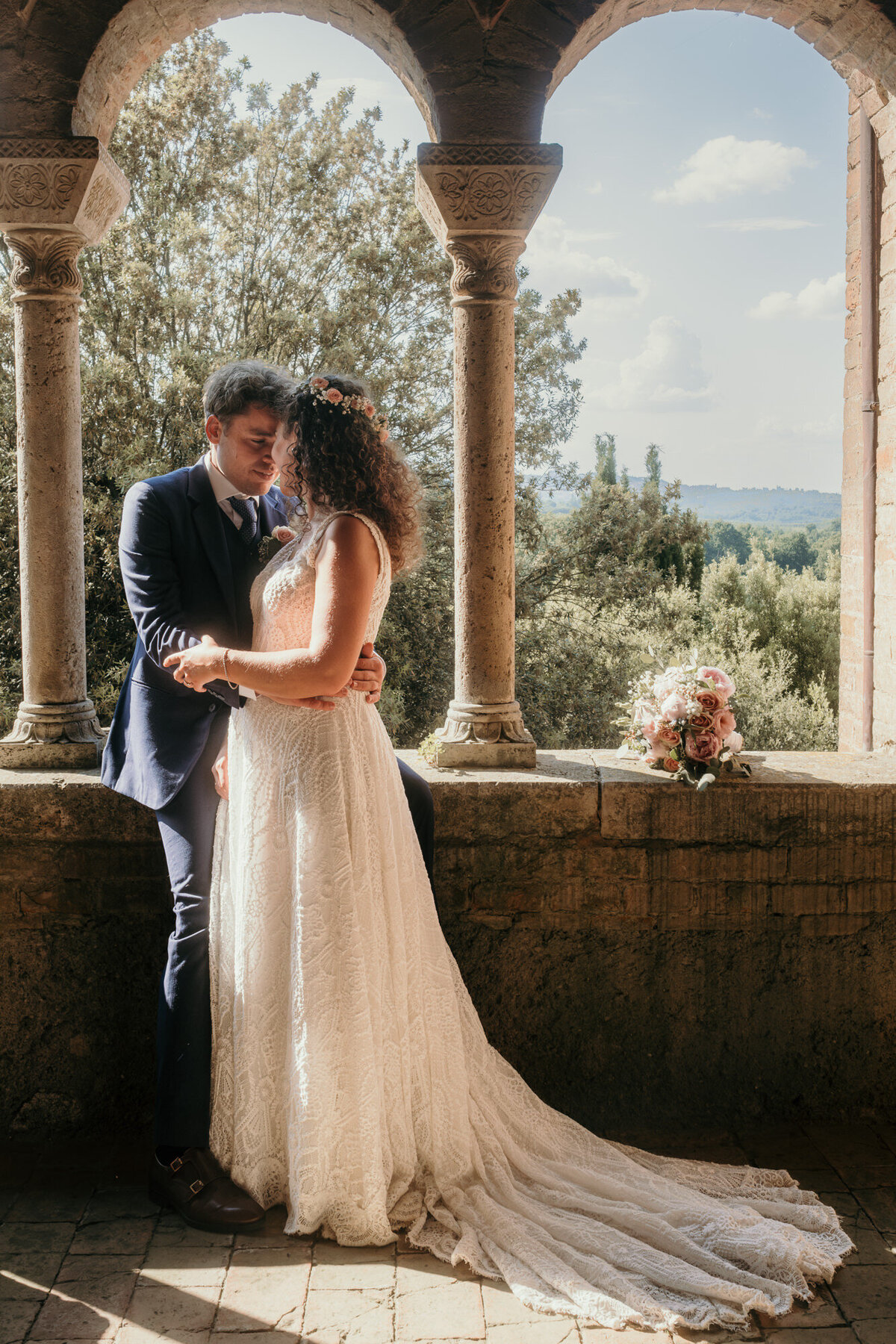 Visibly in love this wedding couple shares an intimate moment during their wedding session in tuscany.