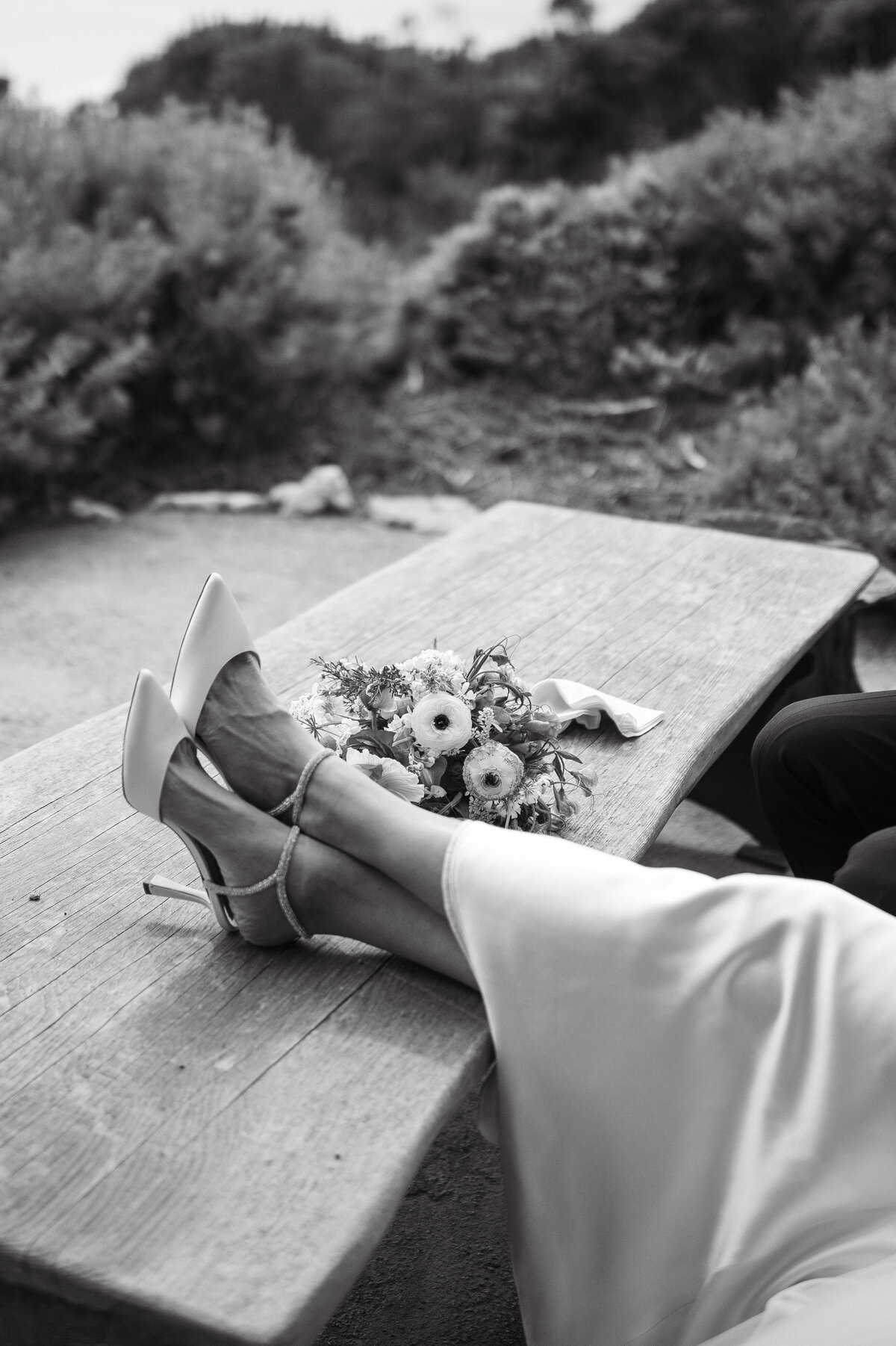 Wedding Photographer & Videographer, close up of brides feet up on a table