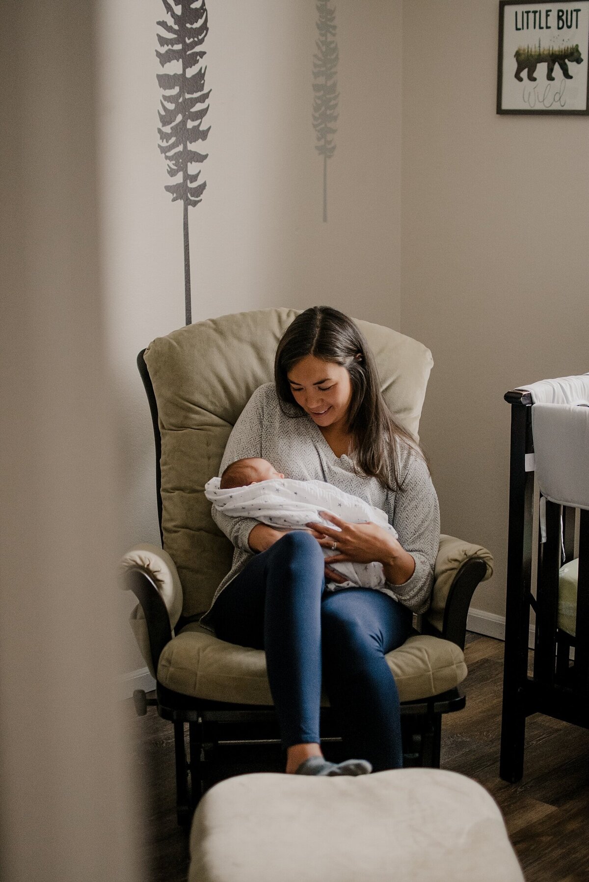 Mother rocks baby captured by Loveland Newborn Photographer