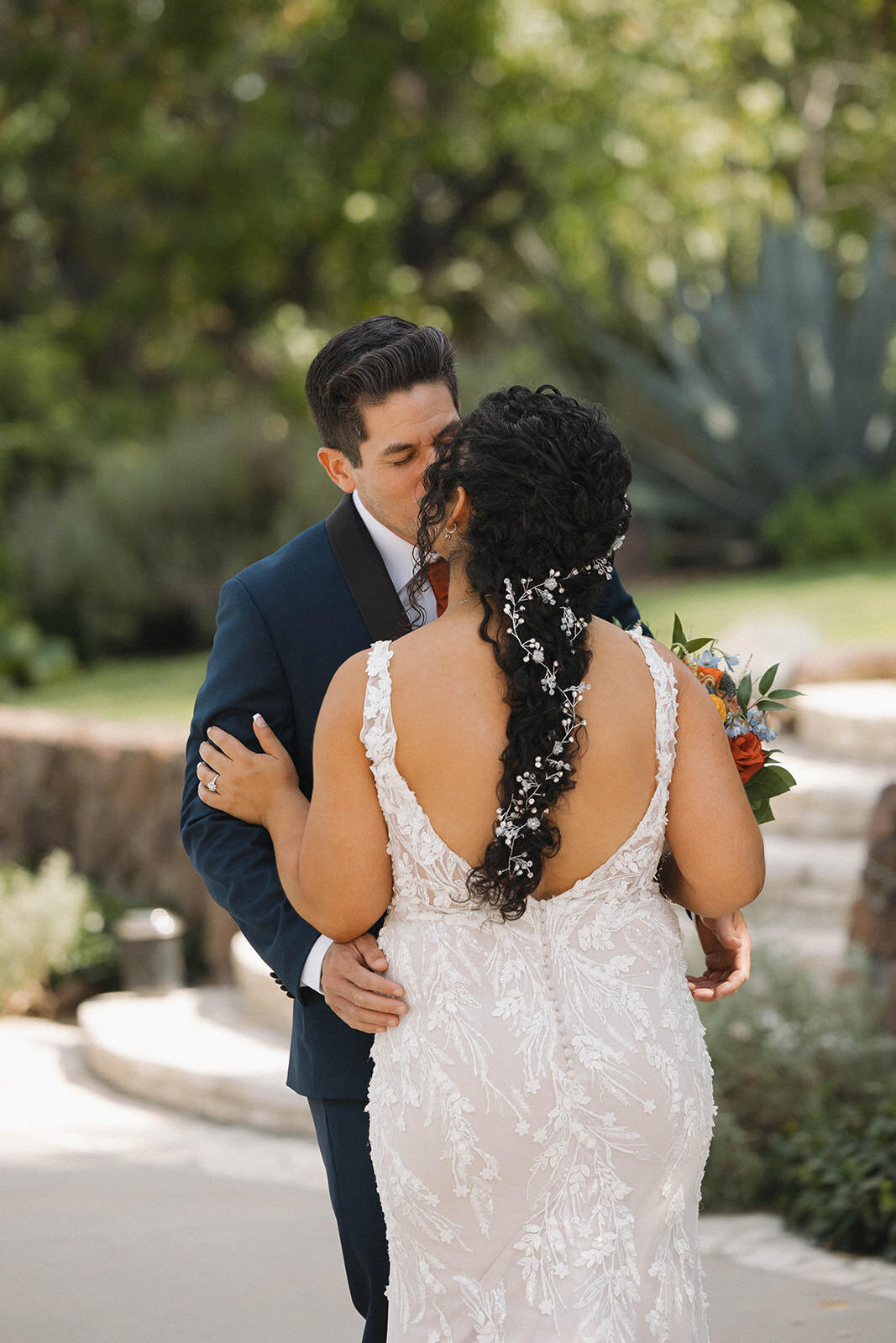 First look embrace in the garden