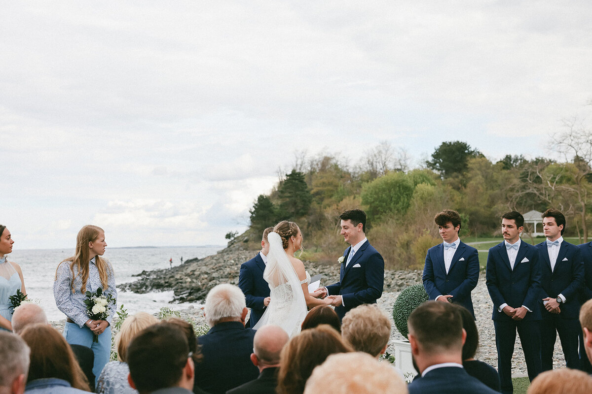 Groom’s emotional reaction as he smiles during vows on the coast of Nahant, MA.