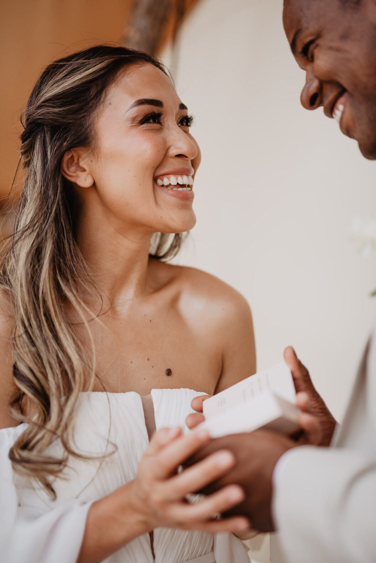 Utah Elopement Photographer captures woman smiling at man after opening gift
