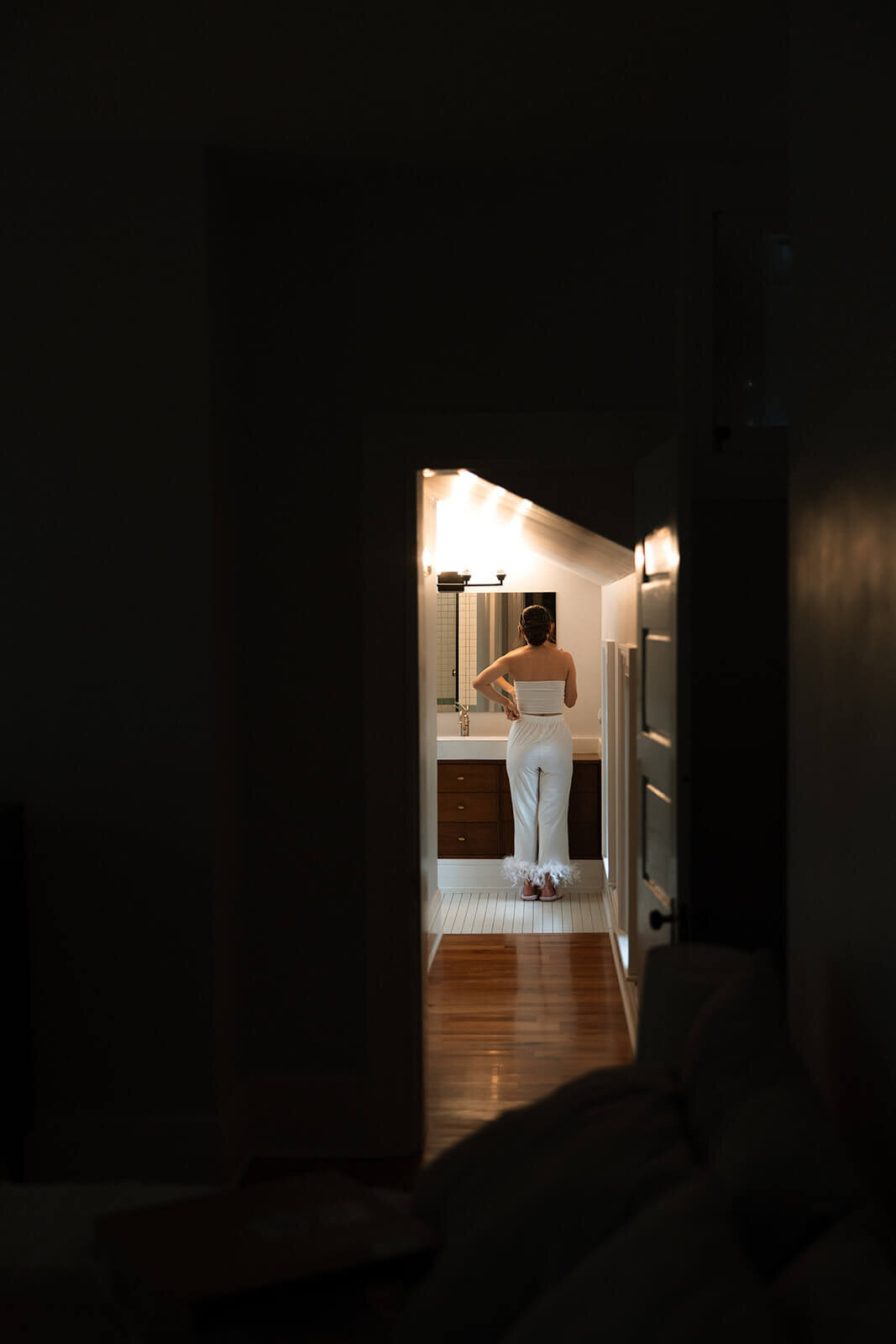 Woman standing in front of mirror at Finger Lakes wedding, New York