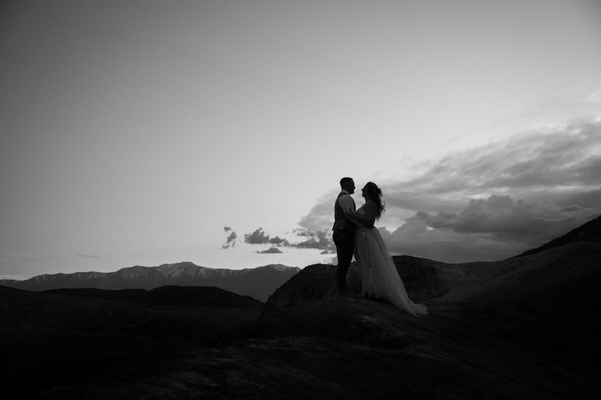 A couple standing at a mountaintop together