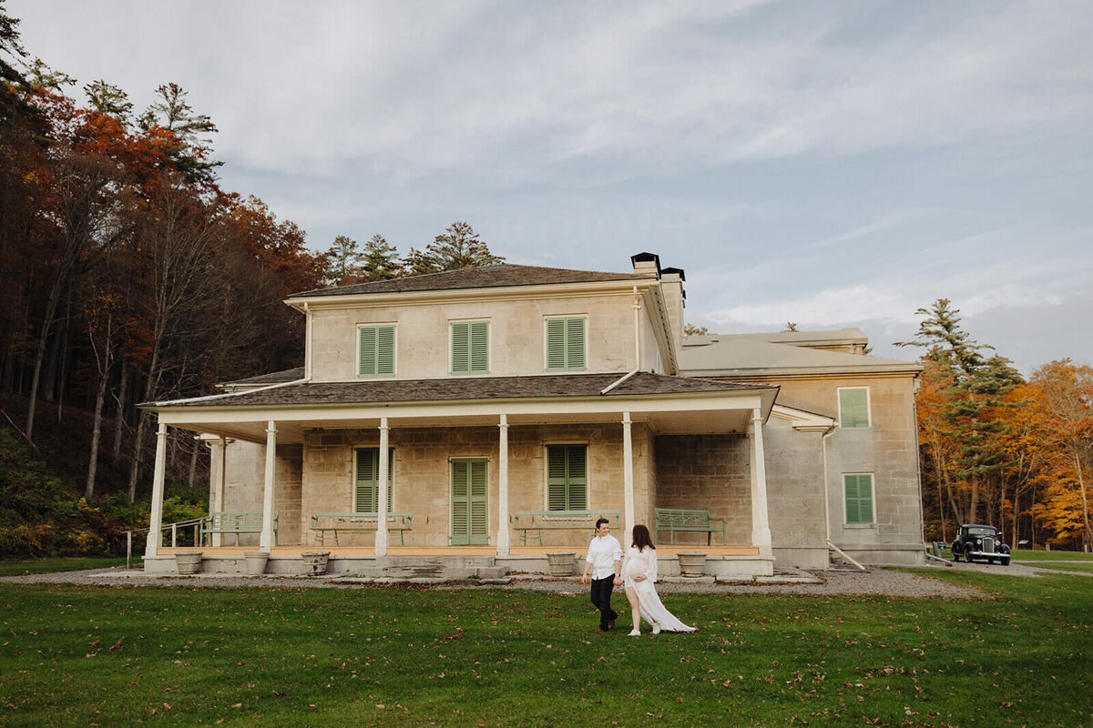 Couple in front of historical building  in Finger Lakes, NY maternity session