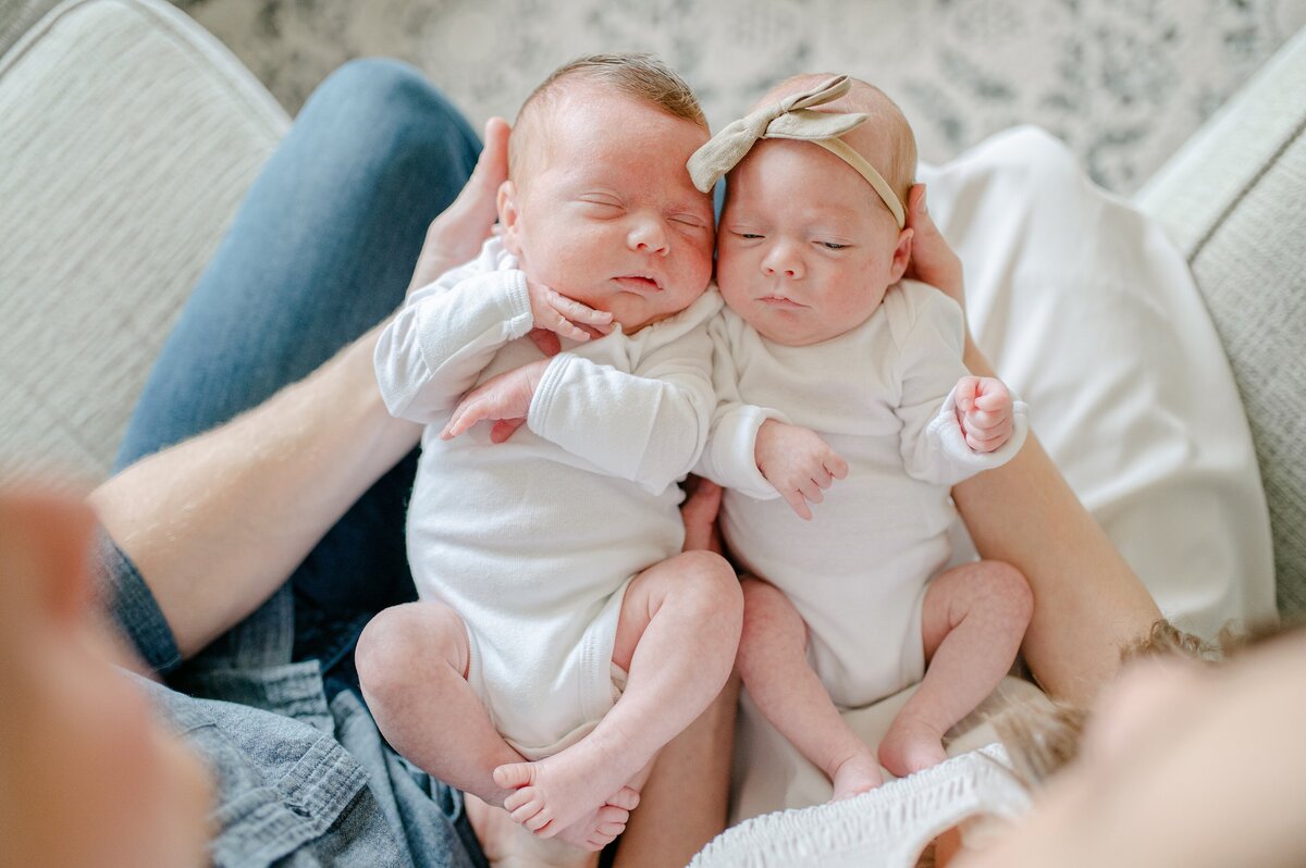 Twins held next to eachother at Milwakee newborn session