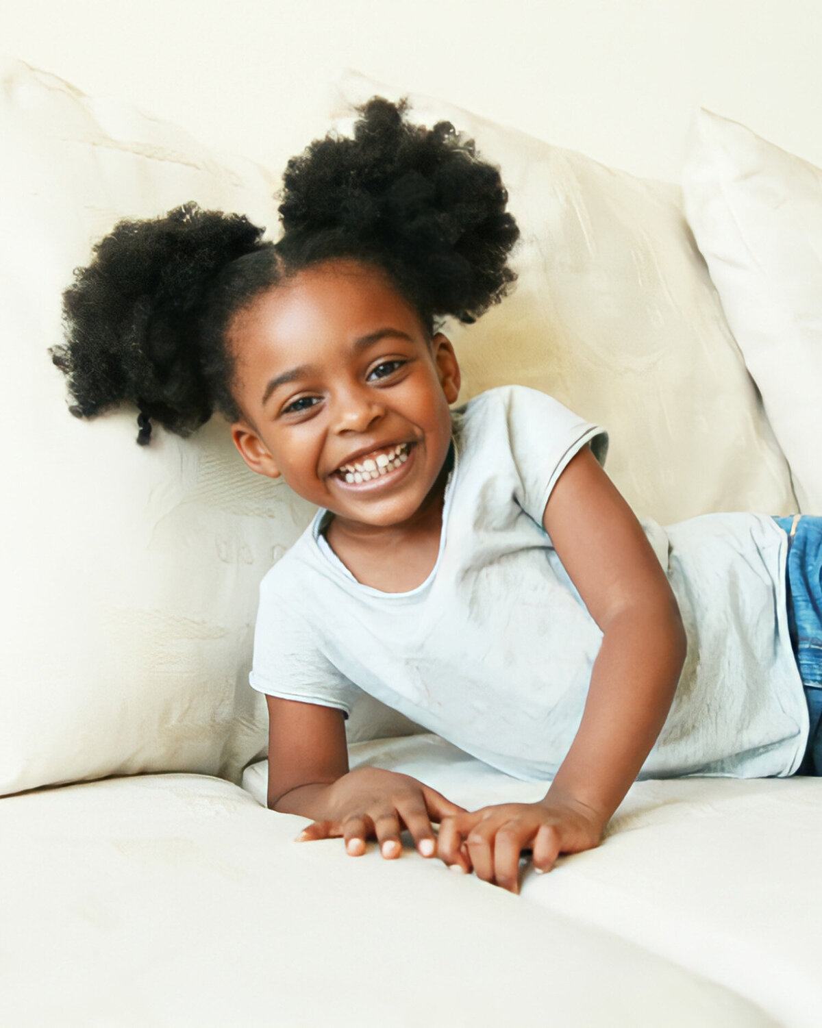 Natural family portrait Palo Alto — African American toddler laying on couch in living room