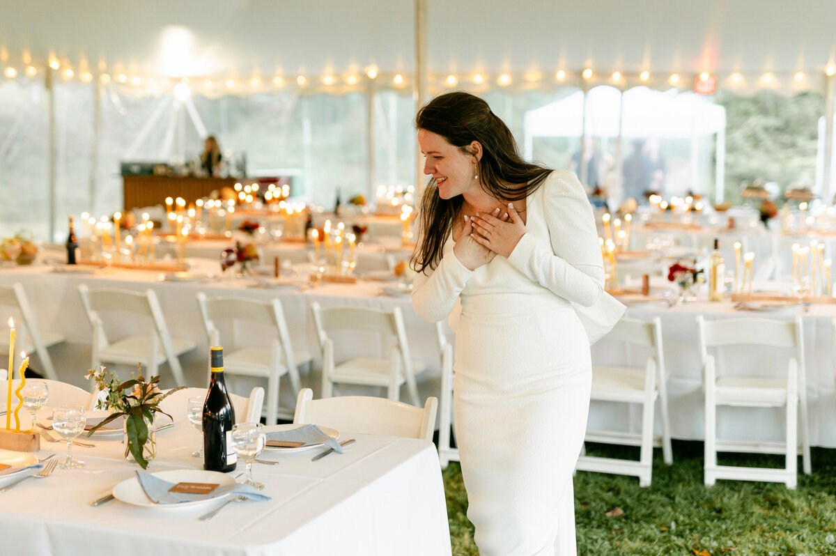 Bride looking at the wedding tables designed by One Bell Designs