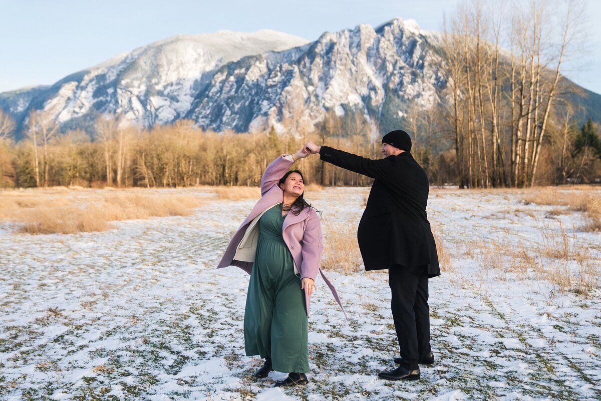 Husband twirling wife during Snoqualmie maternity photos, Mount Si maternity photos