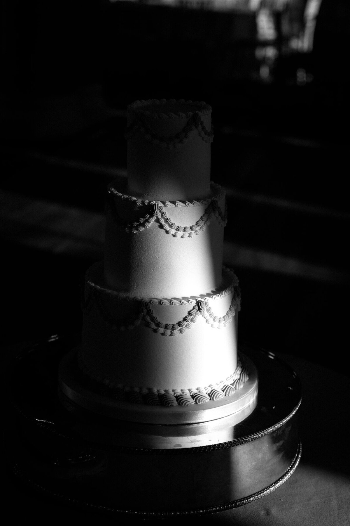 A 3 tiered wedding cake at the Balmoral Hotel Edinburgh with the sun shining on it