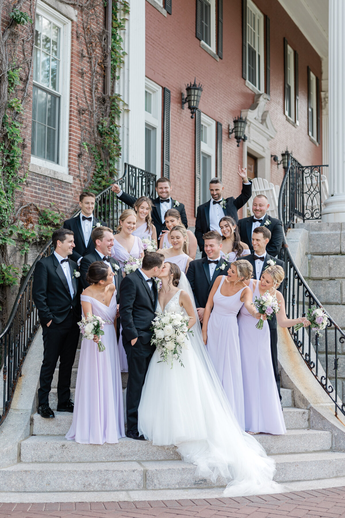 A wedding party celebrates at Holy Cross as the bride and groom kiss