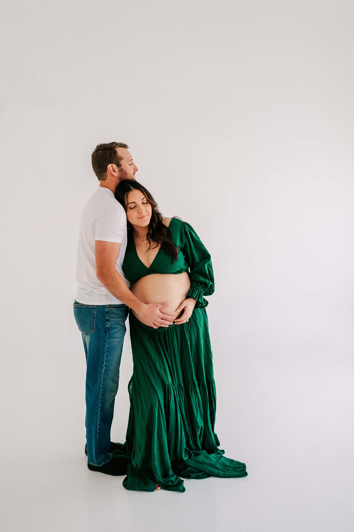 pregnant mom leaning on husband's shoulder during Joplin Mo materniy photography session
