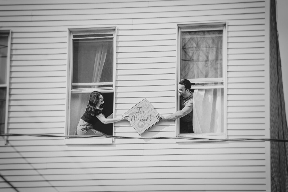 A couple passing a sign between two windows