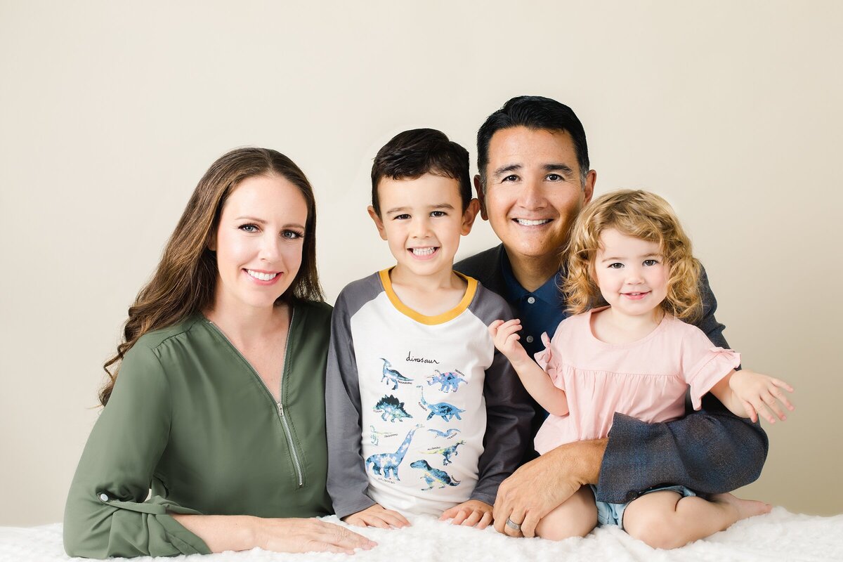 smiling-posed-family-studio-photography-coordinated-well-dressed