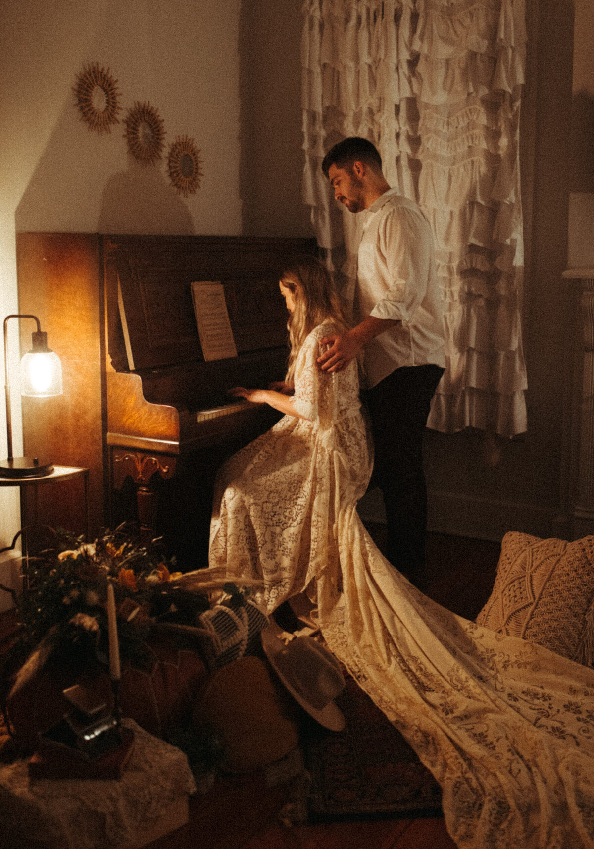 Boho bride playing piano at Airbnb during their elopement reception