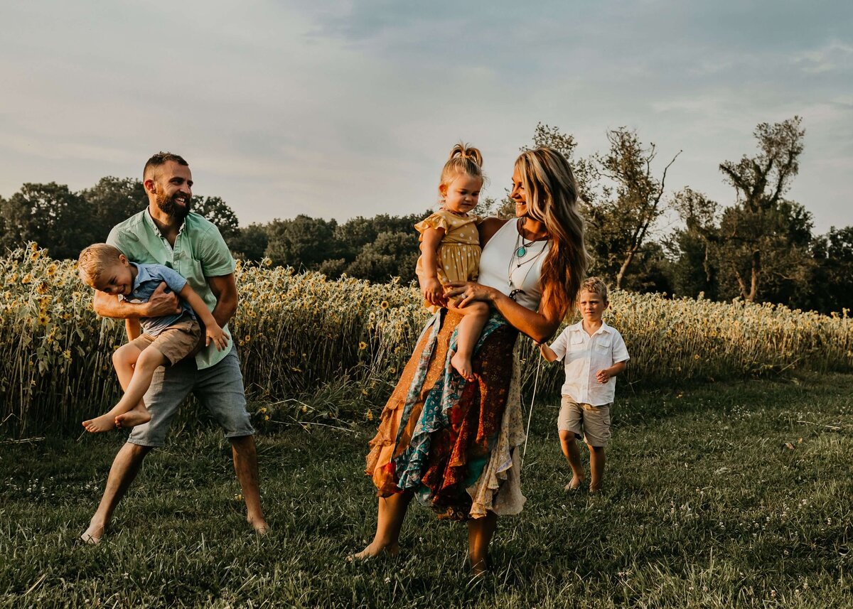 A Pittsburgh family photographer capturing a family in a field with their children.