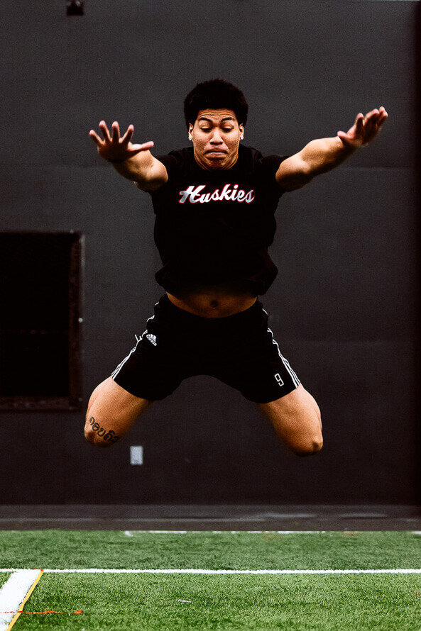 NFL hopeful jumps straight toward camera.