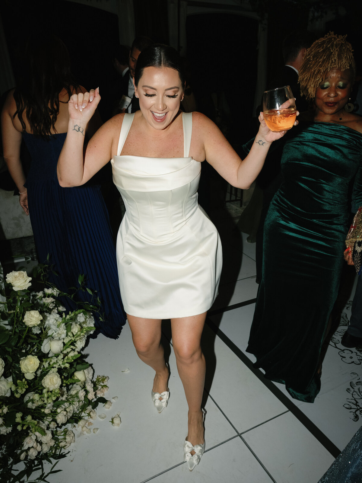 The bride dances in her chic reception dress during the lively fall wedding celebration at Castle Ladyhawke.