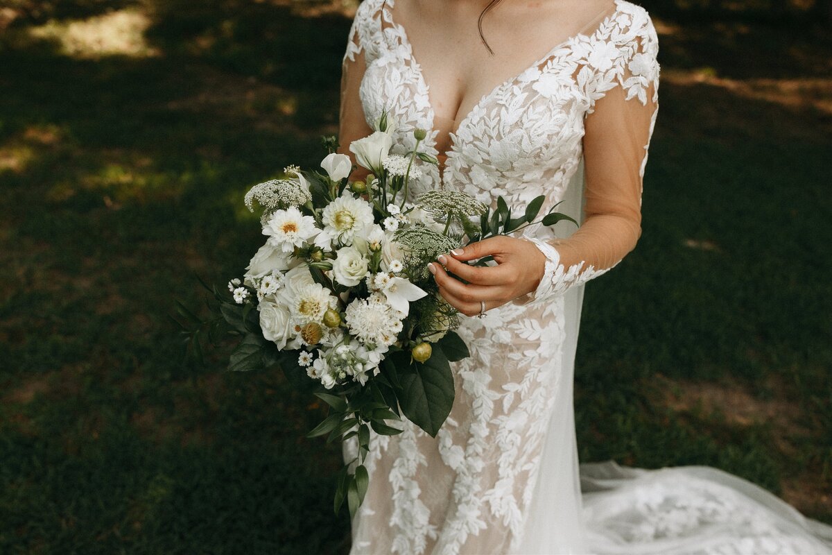 bride holding white flower bouquet