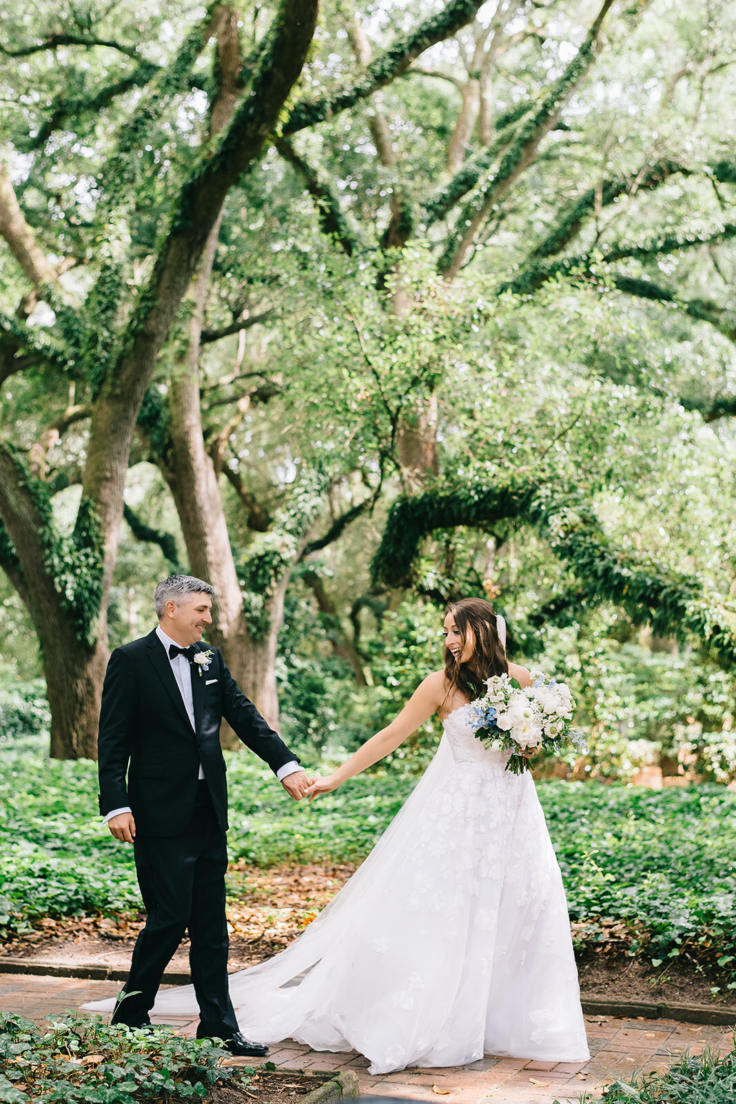 Bride and groom with white and blue bouquet designed by Abby Grace Florals at Greenville SC wedding
