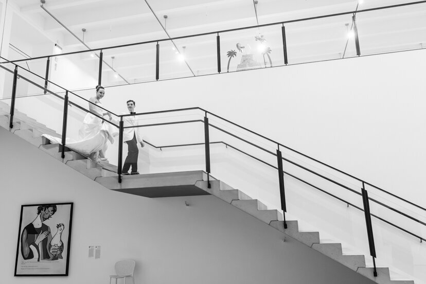 groom-and-bride-walking-down-stairs-at-museum-of-contemporary-arts-san-diego-wedding