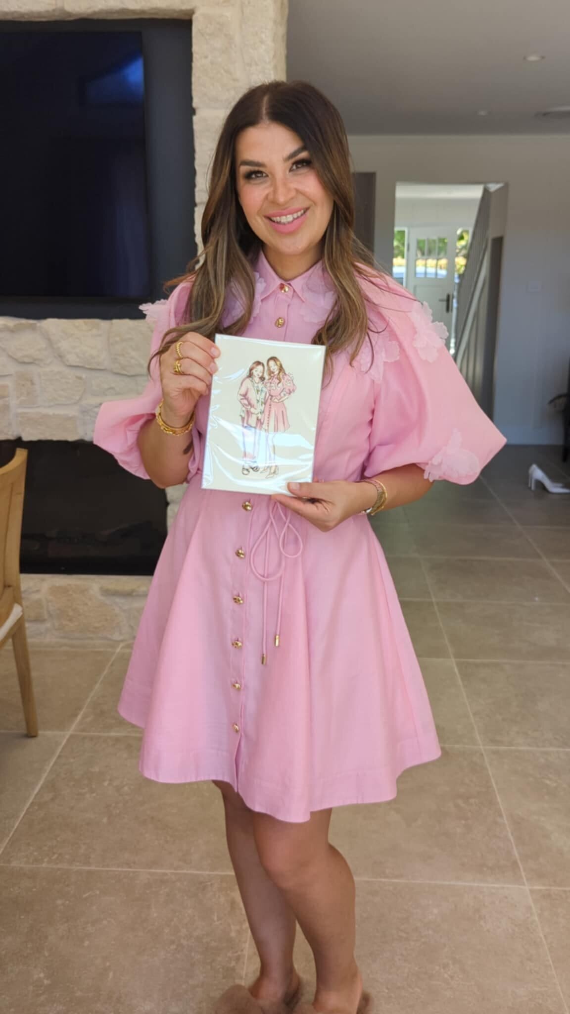 guest-holding-live-wedding-portrait-in-pink-dress