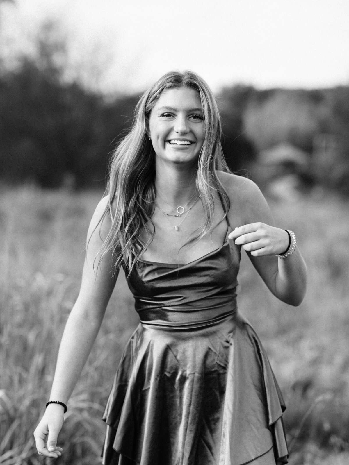 black and whit photo of senior girl in a field at Westcreek Reservation in Parma, Ohio