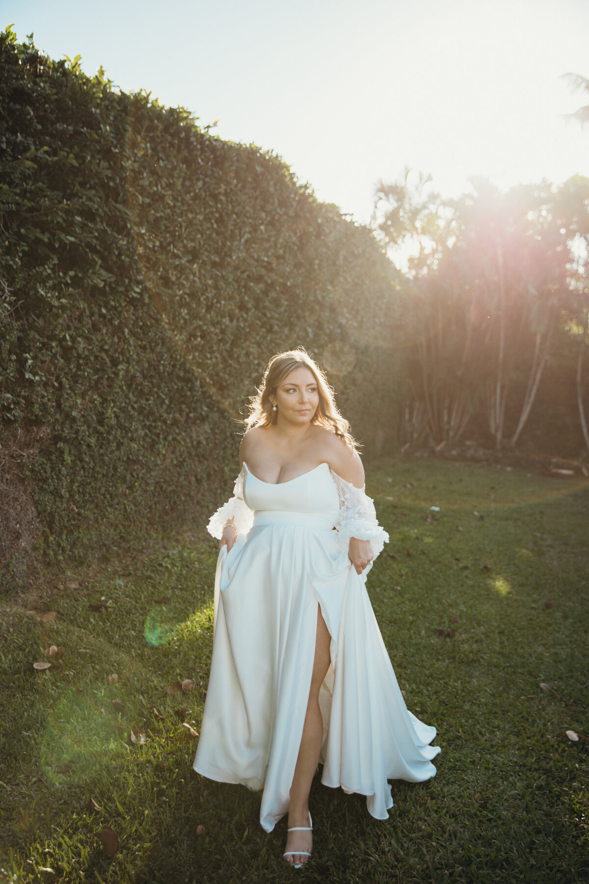 Maui Wedding Photographer captures bride walking with hands in wedding dress pockets