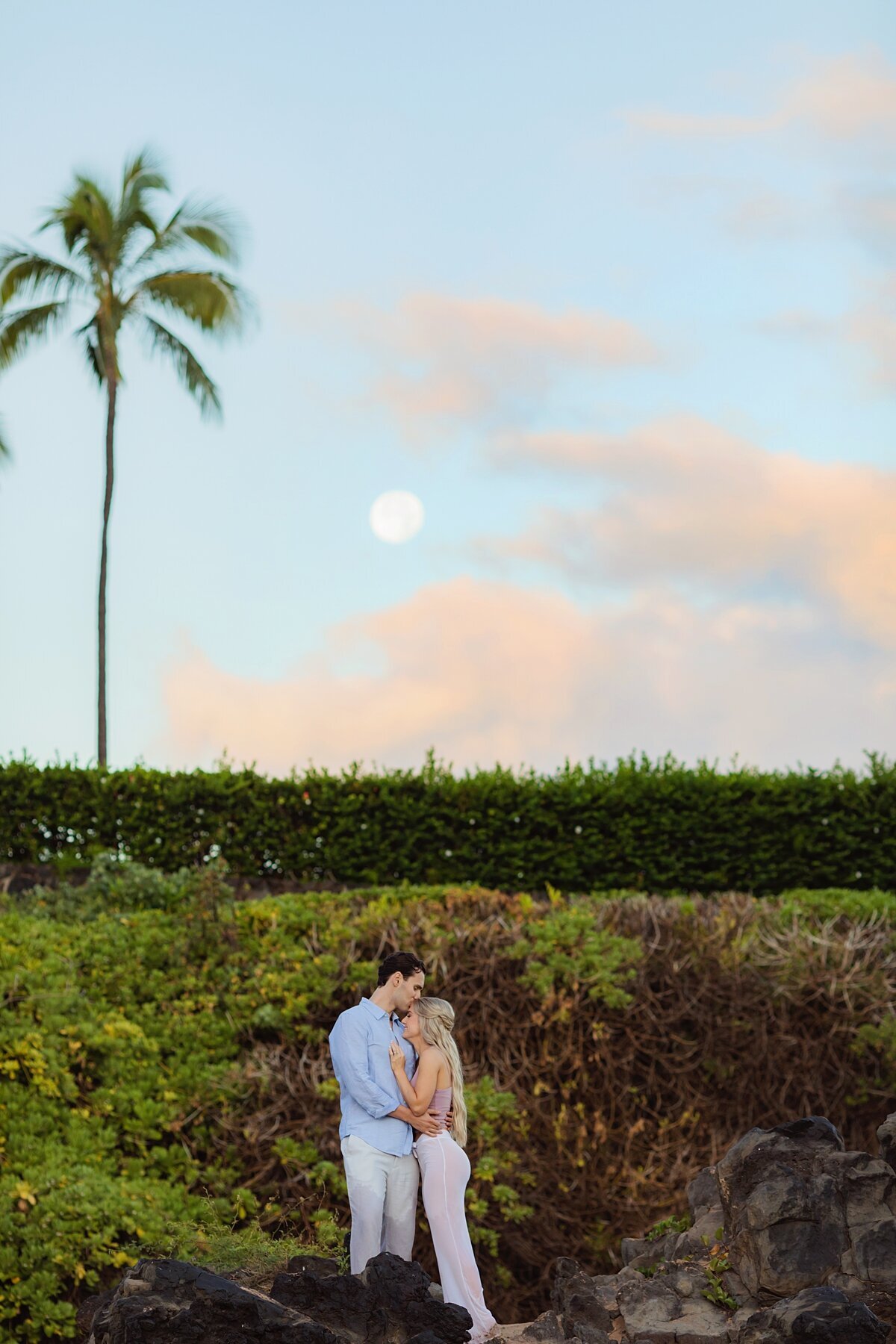A couple photographed under a full moon by Love + Water outside the Four Seasons in Wailea