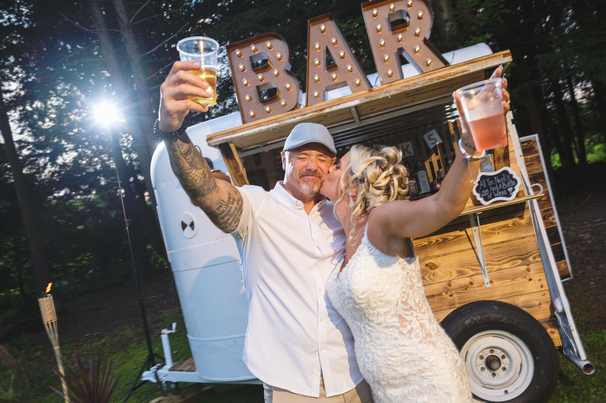 Wedding couple drinking beer at bar.