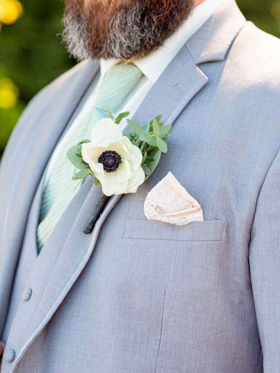 Flower boutonniere on a groom's suit during his wedding at the Guilford Yacht Club.