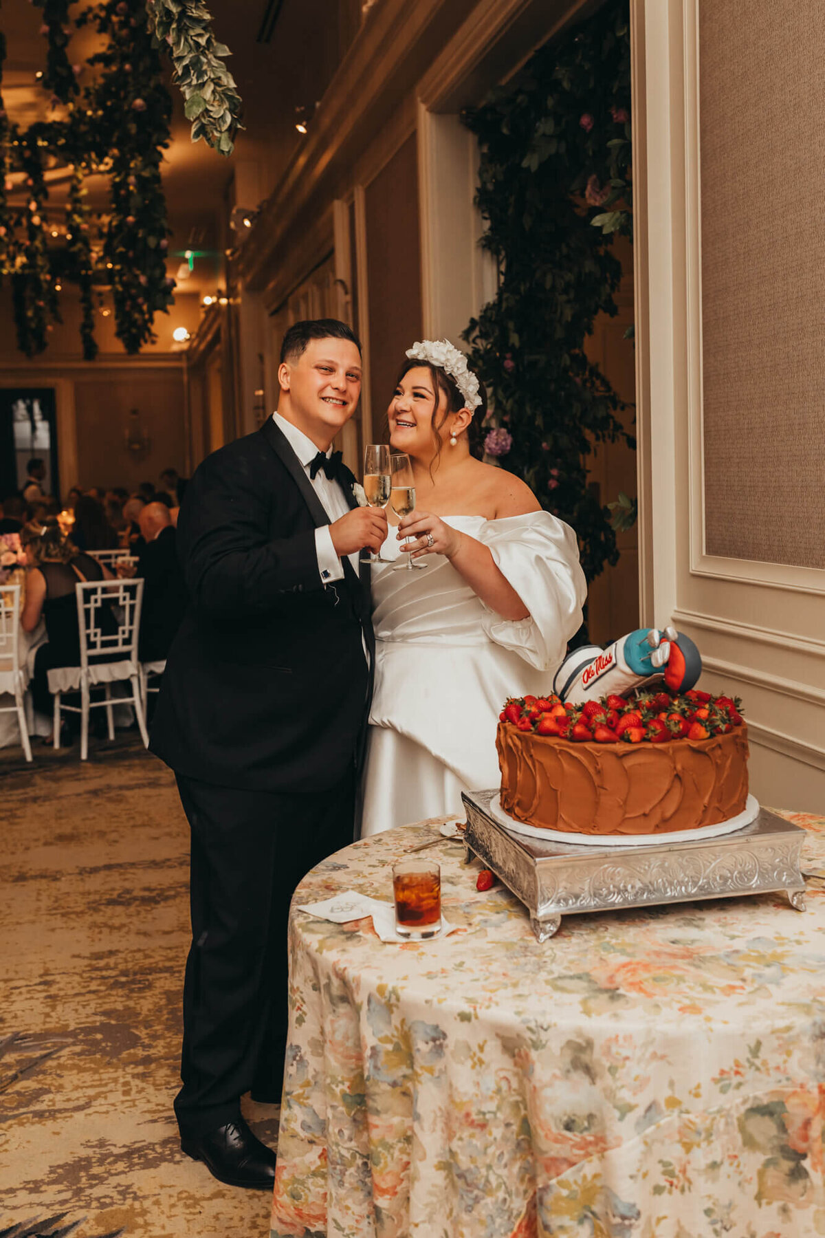 newlyweds cut grooms cake for ally's photography