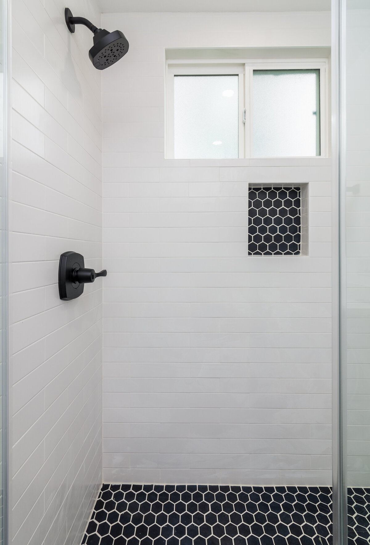 Modern-white-shower-with-black-tile-floor-aw-development