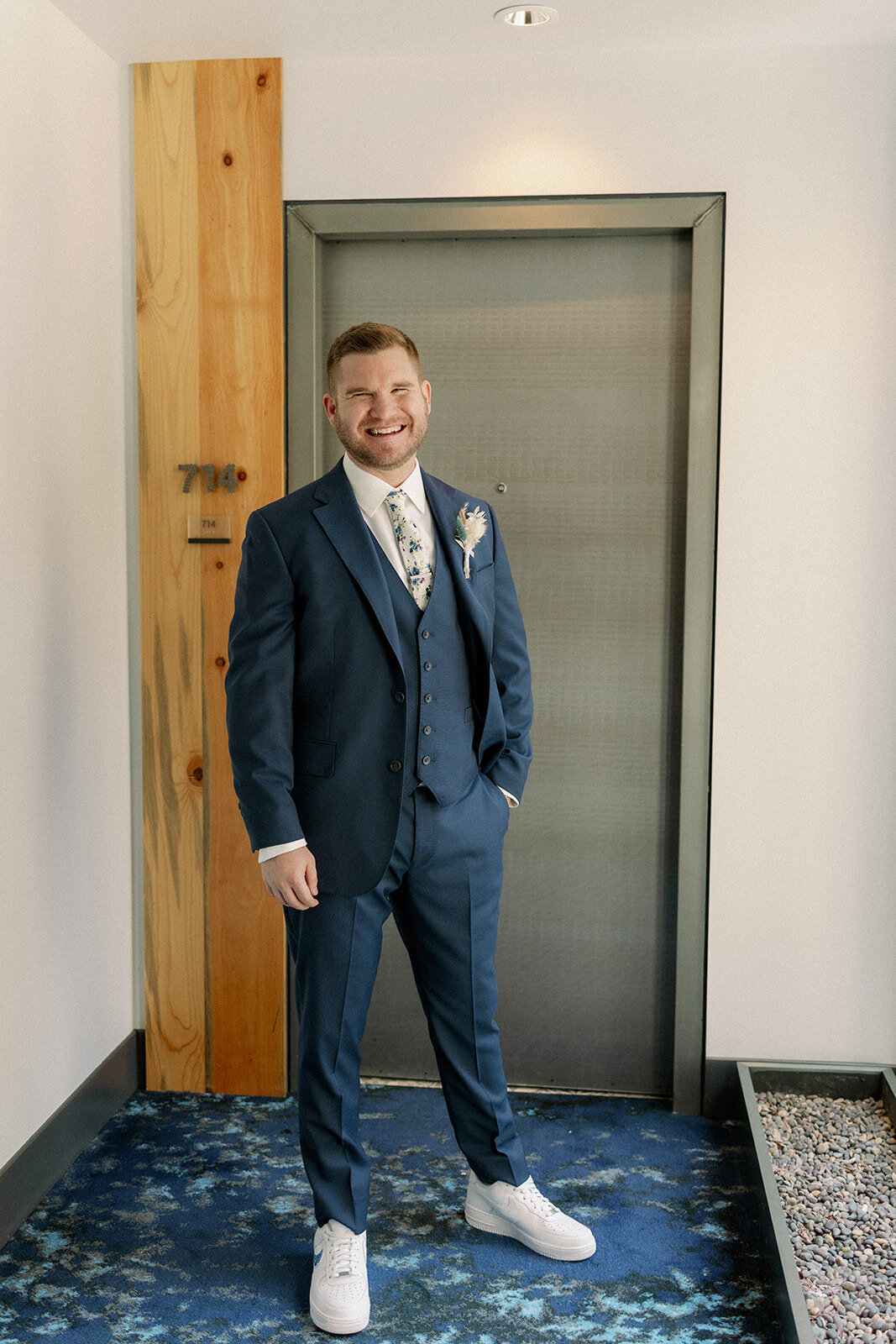 Groom on his wedding day in a navy blue tuxedo.