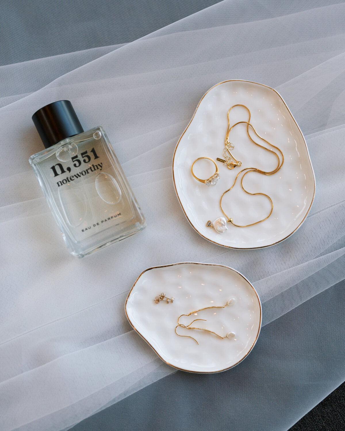 Wedding day details laying on a veil