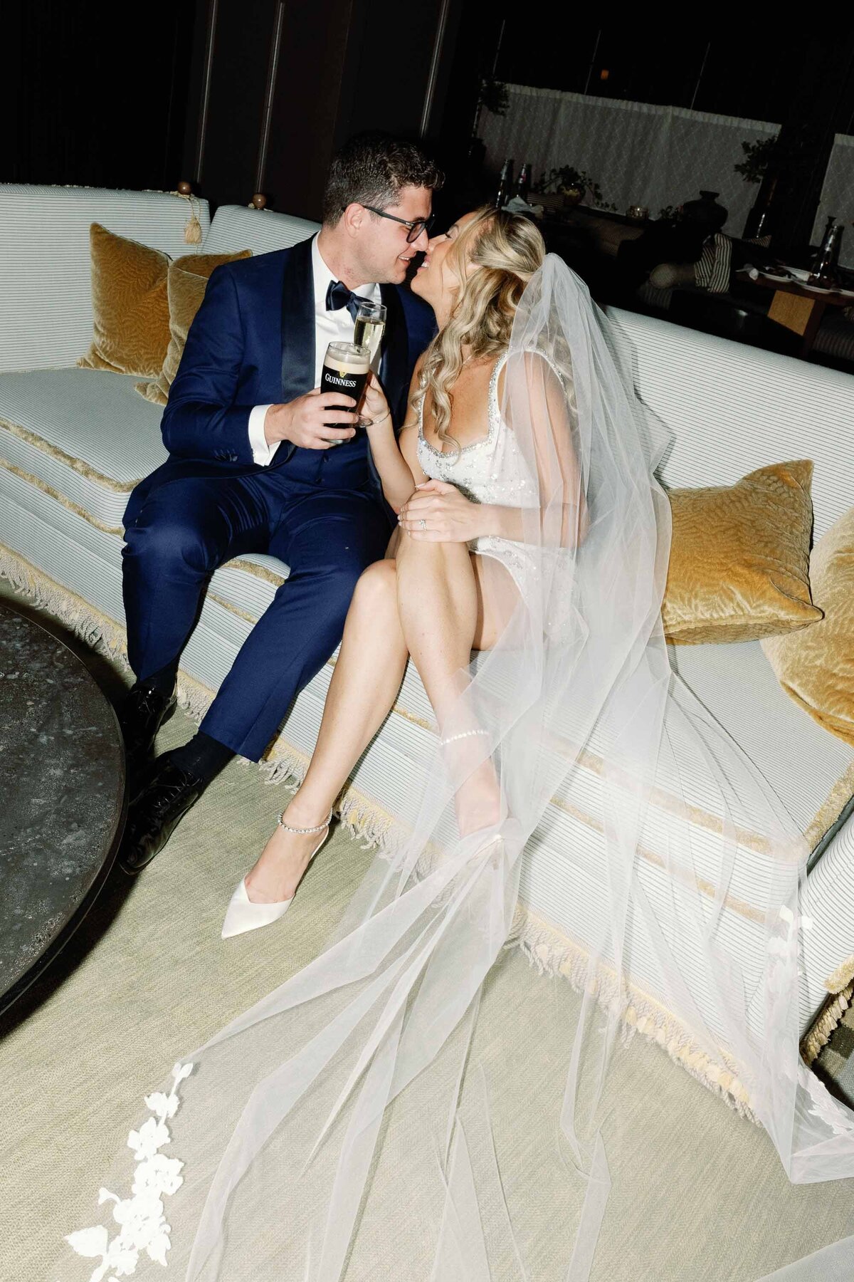 wedding couple kisses on couch at the canoe place wedding in the hamptons long island ny late night flash photography