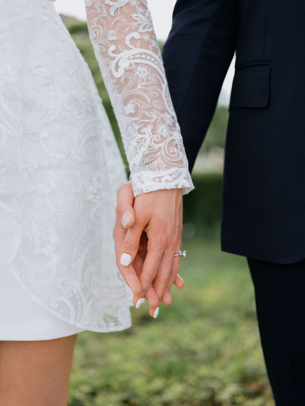 Couple holding hands during their Cleveland Art Museum engagement session.