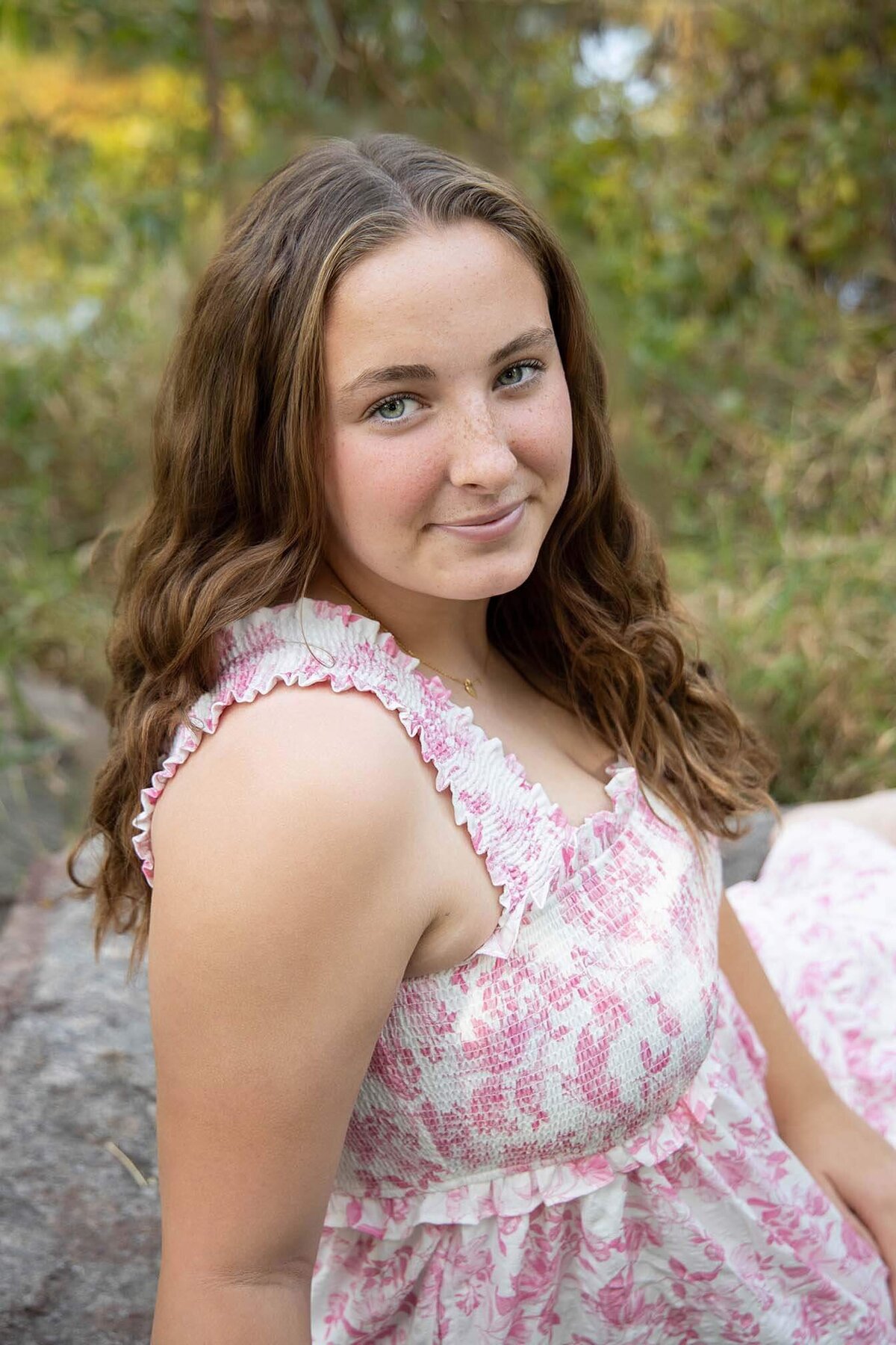 senior-girl-in-pink-dress-on-rock