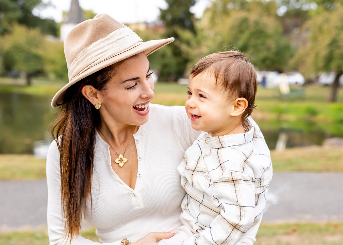 Lifestyle photo of mother and son hugging at a NJ park in the fall.