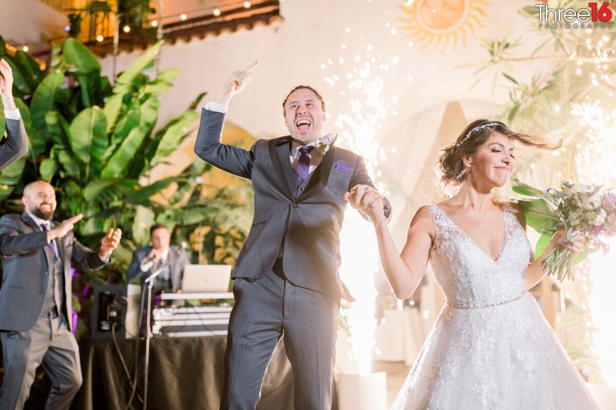 Bride and Groom enter their wedding reception full of excitement