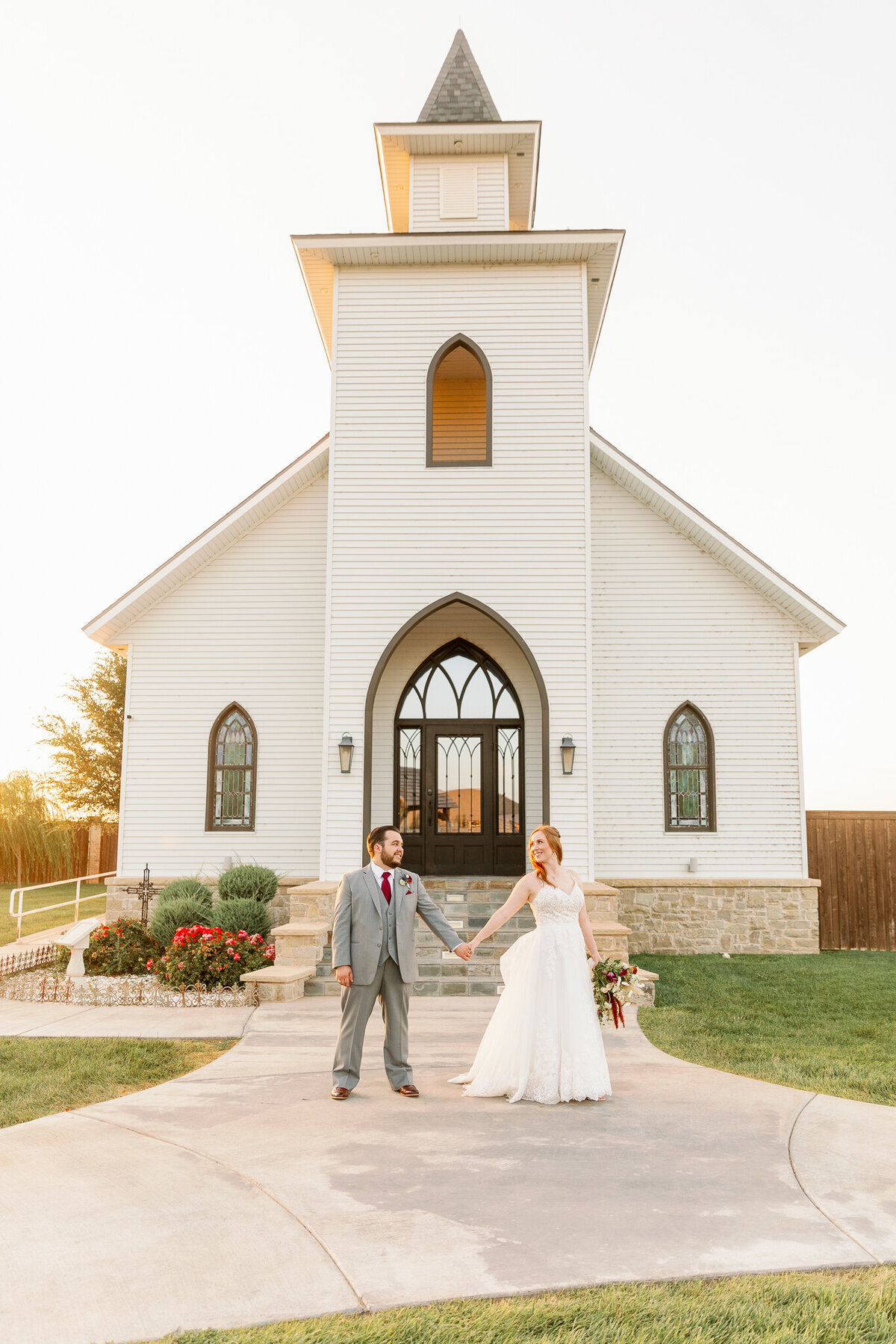 Glowing bride and groom photographed in front of a wedding chapel in Lubbock, Texas