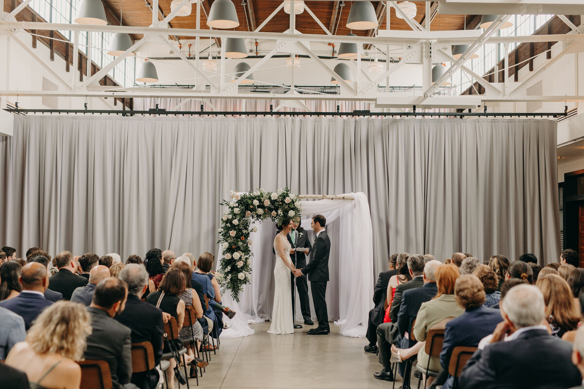 Couple holding ceremony at Olive + Oak wedding venue
